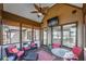 Cozy sunroom featuring a ceiling fan, comfortable seating, and views of the backyard and neighborhood at 2674 Hosanna Dr, Powder Springs, GA 30127