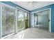 Enclosed balcony with serene views, ceiling fan, and updated floor at 66 Fair Haven Se Way, Smyrna, GA 30080