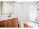 Clean bathroom with tub, vanity, and toilet with modern fixtures and wood-look floors at 66 Fair Haven Se Way, Smyrna, GA 30080