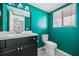 Bathroom with black vanity, bright blue walls, and a window at 66 Fair Haven Se Way, Smyrna, GA 30080