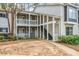 Exterior view of condo with two levels, front staircase, and gray and white siding at 66 Fair Haven Se Way, Smyrna, GA 30080