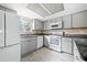 Renovated kitchen features stainless appliances, granite countertops, and light gray cabinets at 66 Fair Haven Se Way, Smyrna, GA 30080