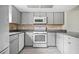 Charming kitchen with gray cabinets, tile backsplash, and modern appliances at 66 Fair Haven Se Way, Smyrna, GA 30080