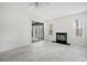 Cozy living room with updated flooring, a fireplace, and a glass door to the outside at 66 Fair Haven Se Way, Smyrna, GA 30080