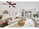 Bright living room features hardwood floors, ceiling fan, and sliding glass doors to outdoor balcony at 66 Fair Haven Se Way, Smyrna, GA 30080