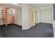 Finished basement features a staircase, closet, and access to other areas, all carpeted at 80 Seville Chase, Atlanta, GA 30328