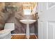 Powder room with pedestal sink, glass shelf, textured wallpaper and modern fixtures at 80 Seville Chase, Atlanta, GA 30328