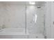 Elegant bathroom features a deep soaking tub, glass enclosed shower, and marble tile surround at 80 Seville Chase, Atlanta, GA 30328