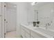 Modern bathroom with double vanity, large mirror, and a glass-enclosed shower-tub combination at 80 Seville Chase, Atlanta, GA 30328