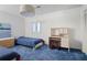 bedroom with twin beds, blue carpet, patterned wallpaper, and built-in desk at 80 Seville Chase, Atlanta, GA 30328