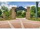 Abernathy Greenway entrance features stone columns, brick pathway, and lush landscaping in a welcoming community setting at 80 Seville Chase, Atlanta, GA 30328