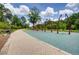 Community playground offers swing set and walking path amidst lush greenery, inviting residents for outdoor activities at 80 Seville Chase, Atlanta, GA 30328