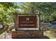 Lost Corner Preserve community sign welcomes residents with natural stone base, and mature trees at 80 Seville Chase, Atlanta, GA 30328