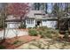 Charming home featuring a well-manicured lawn with mature landscaping and a two-car garage at 80 Seville Chase, Atlanta, GA 30328