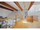 Second floor landing with wood floors, glass railings, wood beams, and skylights at 80 Seville Chase, Atlanta, GA 30328