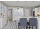 Bright kitchen with stainless steel appliances, island with bar seating and decorative flooring at 80 Seville Chase, Atlanta, GA 30328