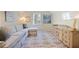 Bright sitting room featuring sectional sofa, patterned rug, and modern wood dresser at 80 Seville Chase, Atlanta, GA 30328