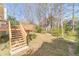 Expansive backyard featuring a wooden deck with stairs descending to the lawn and surrounding trees at 3005 Summit View Ct, Snellville, GA 30078