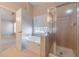 Bathroom with a bathtub and shower with glass doors at 3005 Summit View Ct, Snellville, GA 30078