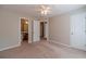 Bedroom showing doorway to the bathroom, neutral colors, carpet, and ceiling fan at 3005 Summit View Ct, Snellville, GA 30078