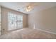 Bright bedroom featuring a ceiling fan and a large window providing ample natural light at 3005 Summit View Ct, Snellville, GA 30078