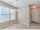 Inviting dining nook features a chandelier, natural light, and view to the entryway at 3005 Summit View Ct, Snellville, GA 30078