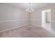 Charming dining room featuring a classic chandelier and neutral color palette at 3005 Summit View Ct, Snellville, GA 30078