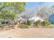 Charming one-story home with white siding, lush landscaping, and a well-maintained front yard at 3005 Summit View Ct, Snellville, GA 30078