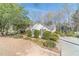 Well-maintained home with green shutters, surrounded by lush landscaping and mature trees at 3005 Summit View Ct, Snellville, GA 30078
