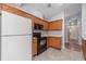 Well-equipped kitchen with wooden cabinets, sleek black appliances, and a view of adjoining rooms at 3005 Summit View Ct, Snellville, GA 30078