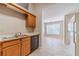 Traditional kitchen with oak cabinets, laminate countertops, neutral tiling, and ample sunlight at 3005 Summit View Ct, Snellville, GA 30078