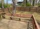 Backyard featuring a wooden deck and a fenced yard with mature trees at 302 Chattahoochee Way, Woodstock, GA 30188