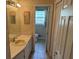 Bathroom with vanity, and view into toilet/shower room featuring neutral colors and fixtures at 302 Chattahoochee Way, Woodstock, GA 30188