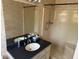 Bathroom featuring a vanity with a black countertop and a tub/shower combo at 302 Chattahoochee Way, Woodstock, GA 30188