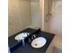 Bathroom featuring a vanity with a black countertop and a tub/shower combo at 302 Chattahoochee Way, Woodstock, GA 30188
