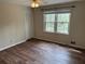 Bedroom with hardwood flooring and natural light from two windows at 302 Chattahoochee Way, Woodstock, GA 30188