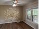 Bright bedroom features decorative wall art, and large windows, with new wood flooring at 302 Chattahoochee Way, Woodstock, GA 30188
