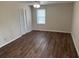 Bedroom showcasing hardwood floors, a ceiling fan, and natural light from a window at 302 Chattahoochee Way, Woodstock, GA 30188