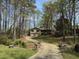 Charming home nestled in wooded area featuring a long driveway and mature trees at 302 Chattahoochee Way, Woodstock, GA 30188