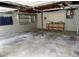 Spacious unfinished garage area with concrete floor, shelving, work bench, peg board, and refrigerator at 302 Chattahoochee Way, Woodstock, GA 30188