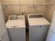 A bright laundry room with modern appliances and convenient shelving at 302 Chattahoochee Way, Woodstock, GA 30188