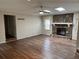 Spacious living room with wood floors, skylights, stone fireplace, and connecting doorway at 302 Chattahoochee Way, Woodstock, GA 30188