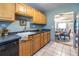 Functional kitchen with light wood cabinets, a black dishwasher, and tile flooring at 520 Park Se Ave # 10, Atlanta, GA 30312