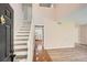 Bright foyer with tiled entry and hardwood steps offers a glimpse into the updated kitchen at 714 Post Road Dr, Stone Mountain, GA 30088