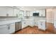 Updated kitchen with new white cabinets, stone countertops, stainless steel appliances and tile flooring at 714 Post Road Dr, Stone Mountain, GA 30088