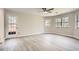 Spacious living room features laminate floors, ample natural light, and a door to the backyard at 714 Post Road Dr, Stone Mountain, GA 30088