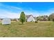 Large grassy backyard with a storage shed and a view of the rear of the home at 95 Summerlyn Dr, Hiram, GA 30141