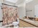 Well-lit bathroom featuring granite counters, a shower with a floral curtain, and neutral finishes at 95 Summerlyn Dr, Hiram, GA 30141