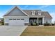 Charming single-Gathering home featuring a two-car garage, manicured lawn, and dormer windows at 95 Summerlyn Dr, Hiram, GA 30141