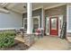 Welcoming front porch with stone accents, comfortable seating, and a charming 